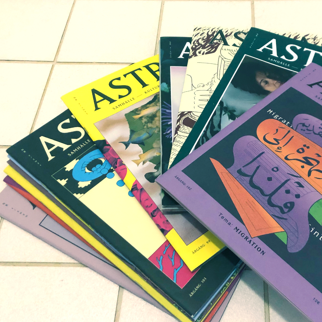 Photo of a pile of Astra magazines on a white tile floor